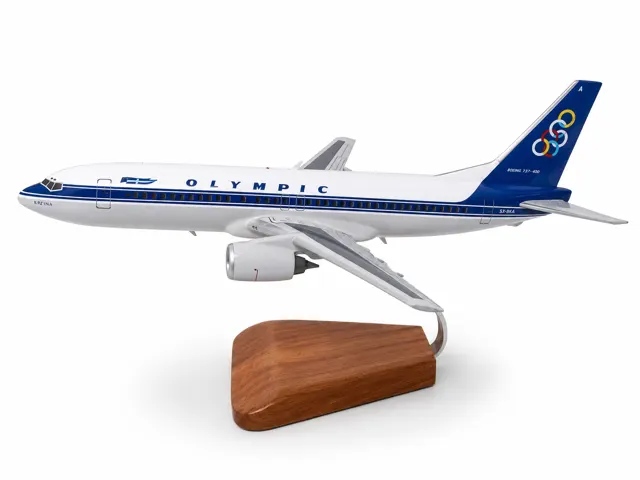Handcrafted Boeing 737-400 model in a classic airline livery with registration SX-BKA on a wooden stand.