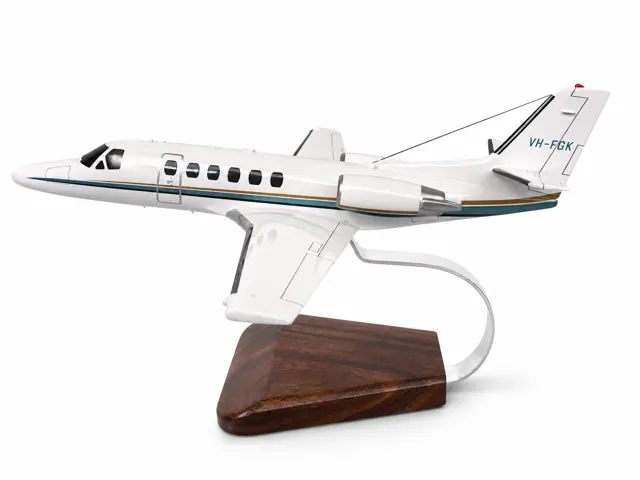 Hand-painted Cessna Citation business jet model with registration VH-FGK and gold-and-teal cheatline.